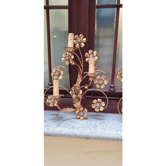 2 golden wrought iron appliques, with sheet metal leaves, the flowers also in sheet metal enclose beautiful cut crystals,...