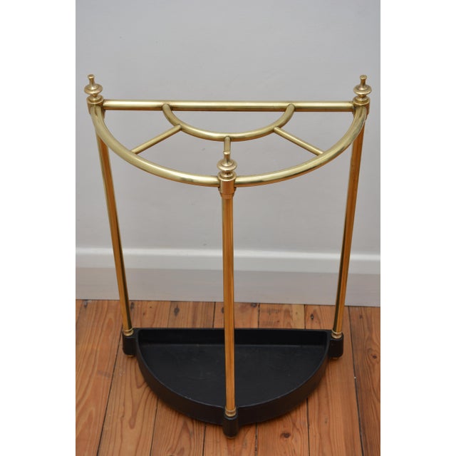 P0330 english half moon umbrella stand in brass, having five divisions with decorative finials, three uprights and black...