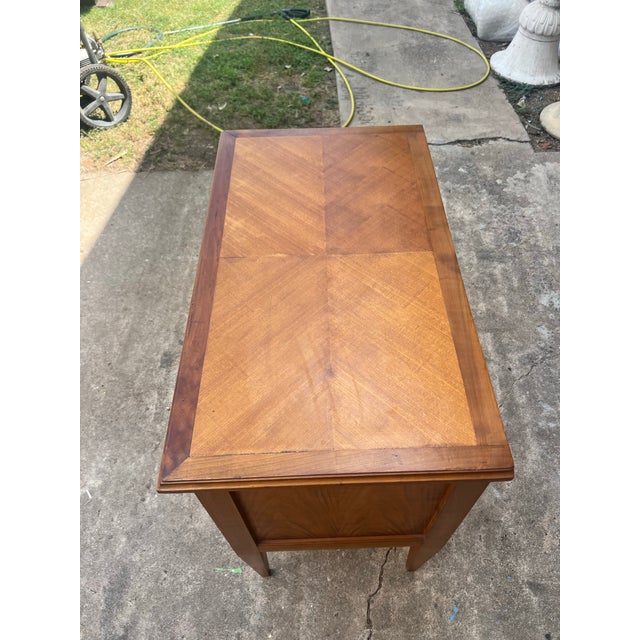 This elegant 19th-century French Louis XVI walnut commode showcases the refined neoclassical style with clean, straight...