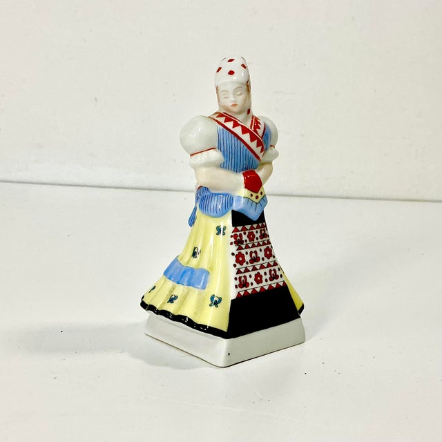 From the high-quality porcelain factory of Herend out of Hungary, we have a hand painted folk dancer figurine. The female...