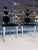Postmodern Memphis style dining chairs featuring steel frame, tapered oak front legs, and triple panel backrest in...