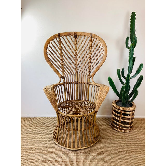 Vintage 1960s Rattan Chair made of rattan natural color tall "peacock" style fan back woven rattan detail at arm in the...