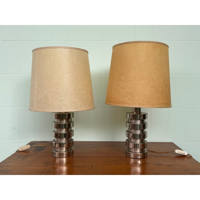 Pair of "Space Age" style lamps with a chromed steel frame and a canvas lampshade. Dating back to the 1970s. The...
