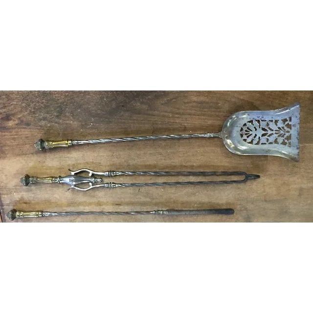 Set of antique 19th century English steel and brass mounted fireplace tools including shovel, tongs and poker. Decorated...