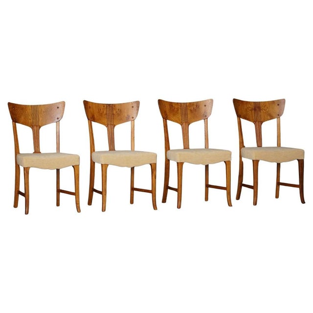 A refined set of four Danish dining chairs made in burl wood, dating to the early 20th century, circa 1900–1915, a period...