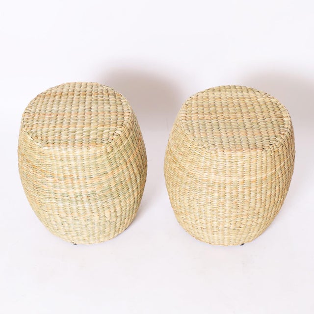 Unusual pair of garden seats hand crafted with a durable metal frame wrapped with reed in classic form.