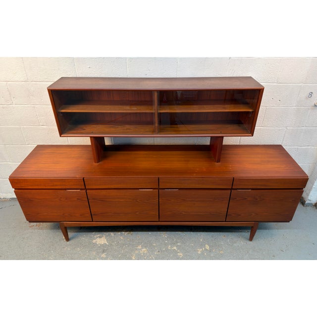 Exceptional vintage FA-66 credenza by Ib Kofod-Larsen for Faarup Møbelfabrik, Denmark, featuring a distinctive glass...