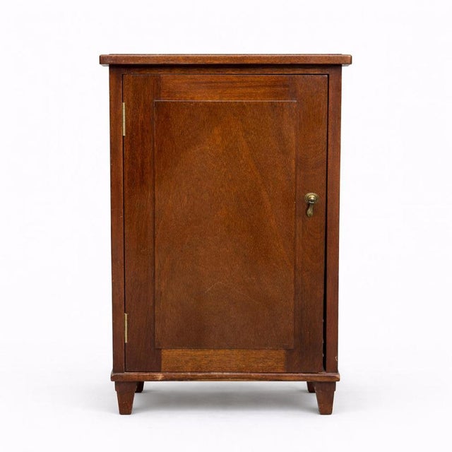 A handsome Arts & Crafts oak record cabinet, designed for the storage and organisation of gramophone records. Crafted in...