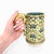 A fine antique Chinese cloisonne enamel tankard. In a tapering cylindrical form with an ear-shaped gilt bronze handle. The...
