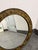 Design Plus Gallery presents a Vintage Round Gilt Metal Floral Medallion Wall Mirror. This circular mirror showcases an...