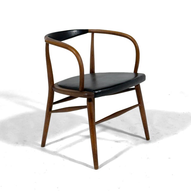 This beautiful walnut armchair was made in Silver City, North Carolina by the Boling Chair Co. however, with its subtle...