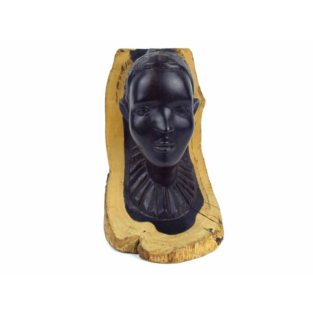 This striking hand-carved bust is a masterful display of the natural edge or live edge technique, where the artisan...