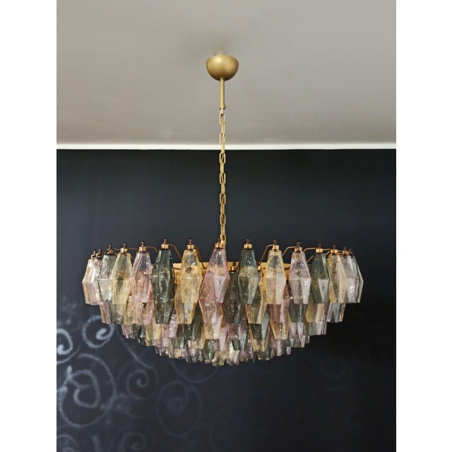 Elegant Italian pendant light made from 185 multicolored Murano glasses "poliedri". Structure in gold and brass colored...