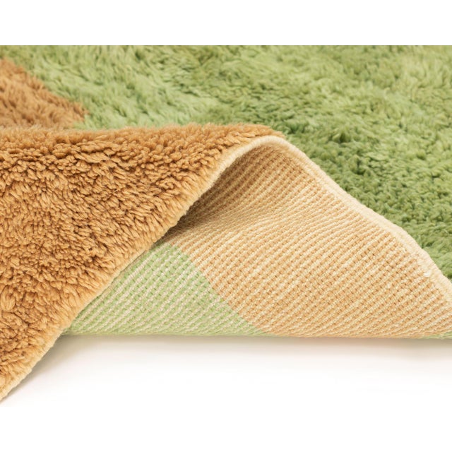 Abstract hand-knotted wool rug featuring a striking abstract design in Sage green, Fawn, and Forest Green, offering a...