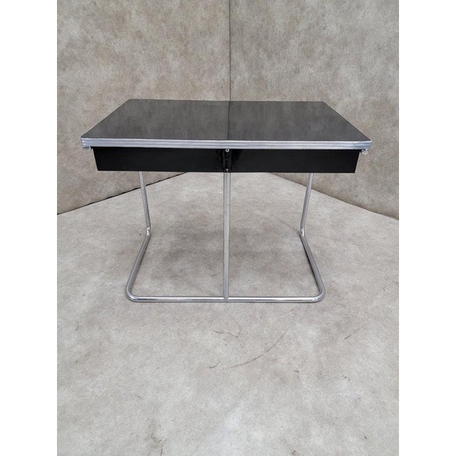 Vintage Art Deco Black Enamel Covered Metal Chrome Tubular Framed 2 Drawer Desk This Vintage Art Deco desk features a...