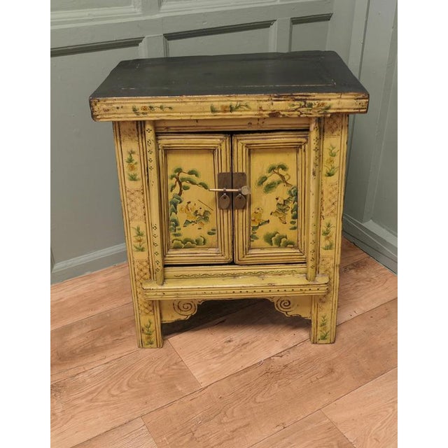 A Superb Cream Lacquered Chinoiserie Decorated Cabinet A Prime example of chinoiserie decor with traditional Chinese...
