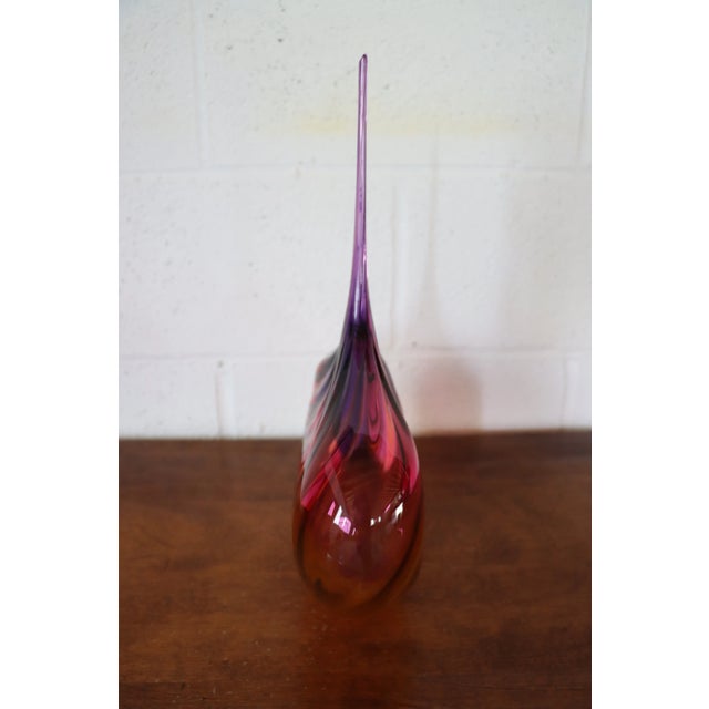Art glass teardrop vase in purple, fuchsia, and amber.