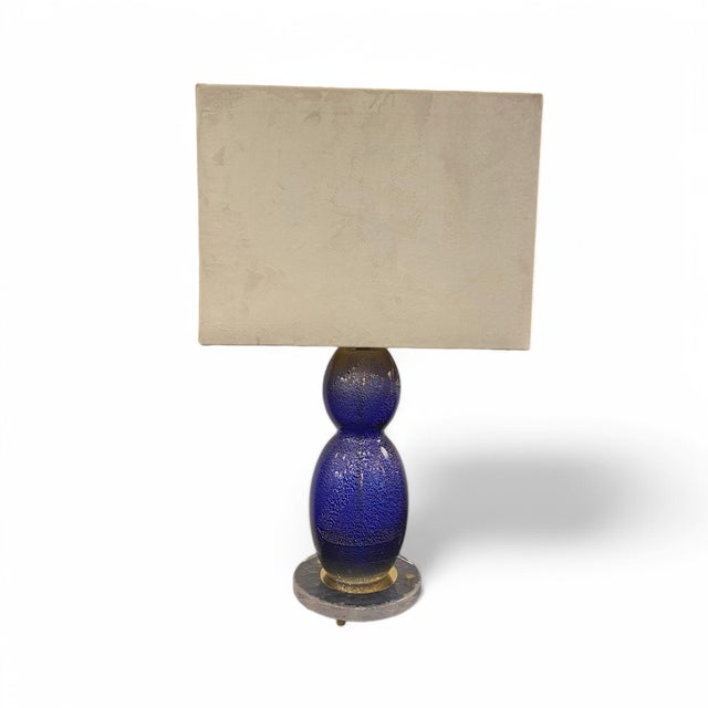 Pair of lamps with bodies made of hand-blown Murano glass, giving them a distinctive, artisanal look. They are finished in...