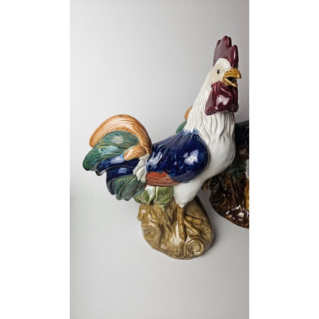 An impressive pair of large vintage ceramic rooster sculptures in the traditional European majolica style, featuring rich,...