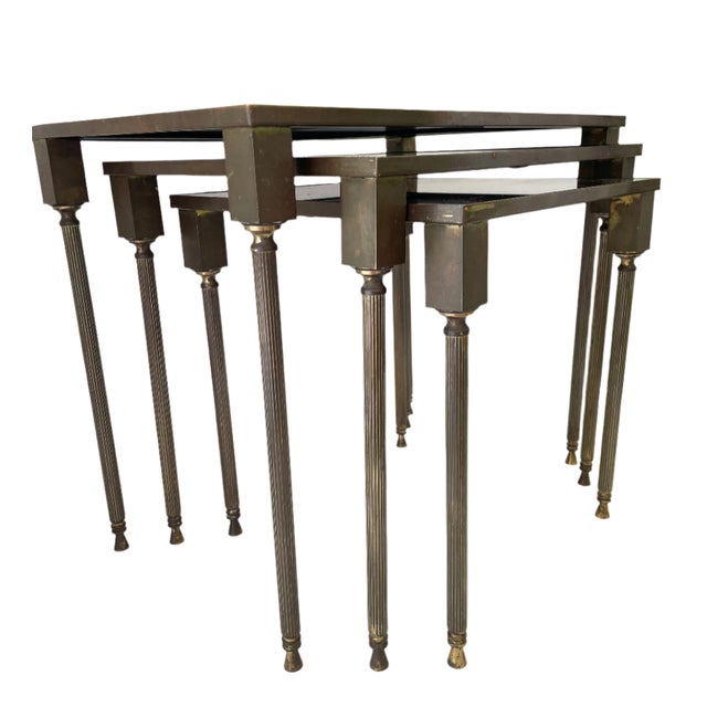 Set of three Brass Nesting Tables with Antiqued Glass Tops. Large: 18"H 20"W 14.5"D Medium: 16.5"H 17"W 13"D Small: 15"H...