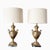 A striking pair of vintage brass table lamps in the Neoclassical style, featuring elegant swan-form handles and finely...