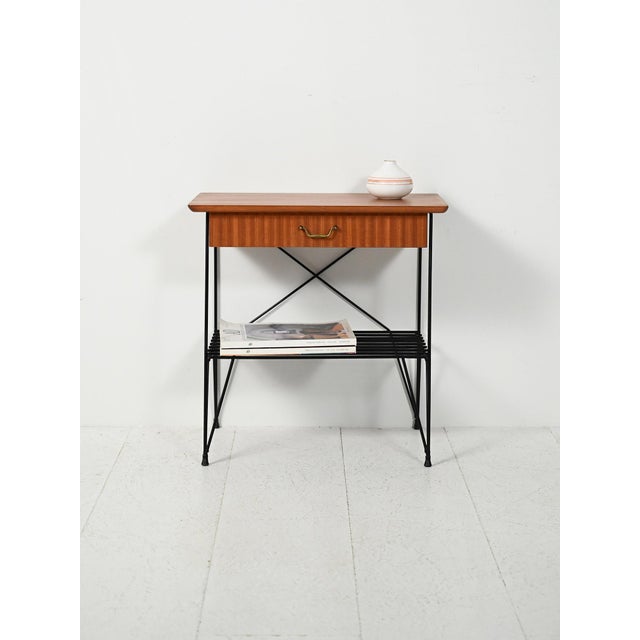 Scandinavian 1960s mahogany and iron bedside table, "Rolf" model by IKEA, with a lightweight frame and brass details....