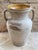 Antique terracotta jar with two handles and a honey-yellow glazed interior, typical of southern Italian country homes....