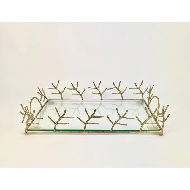 Elegant serving tray in Maison Baguès style with animated branches decoration and handles in golden metal and glass shelf....