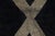 A single, striking gesture — bold, symmetrical, unforgettable. This large hand-knotted Moroccan wool rug commands...
