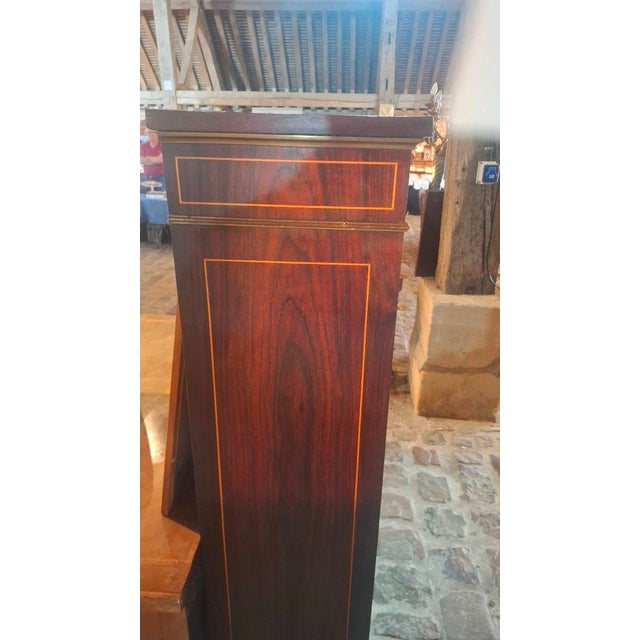 Napoleon III period marquetry display cabinet with two doors and three shelves opening onto two doors. It features rich...