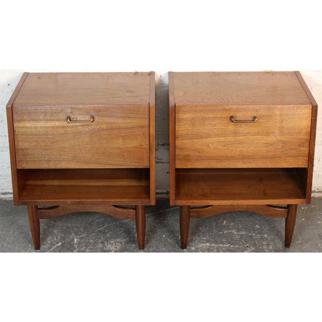 Pair of mid-century modern walnut “Dania” night stands designed by Merton Gershun for American of Martinsville. These...
