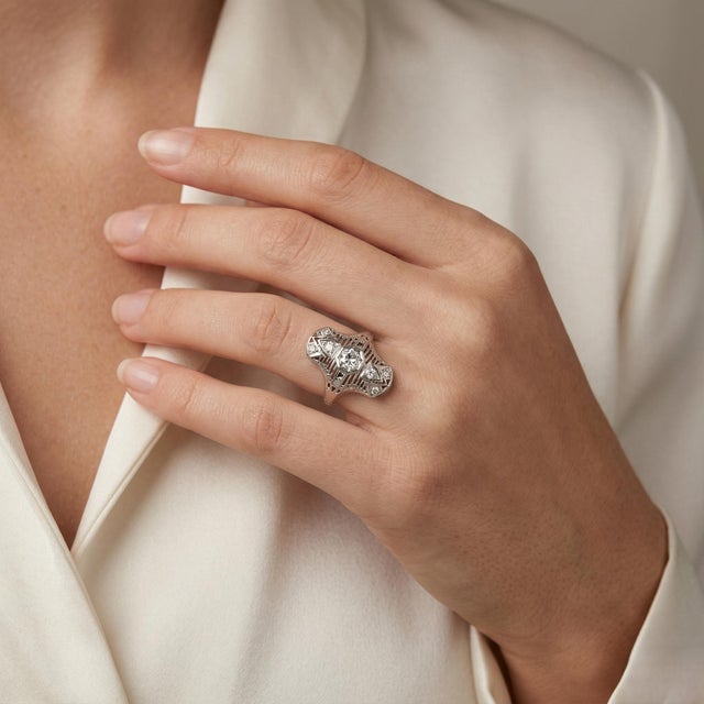 Elegant Art Deco 18K white gold filigree ring featuring an Old European cut natural diamond (0.30 Carat Total Weight),...