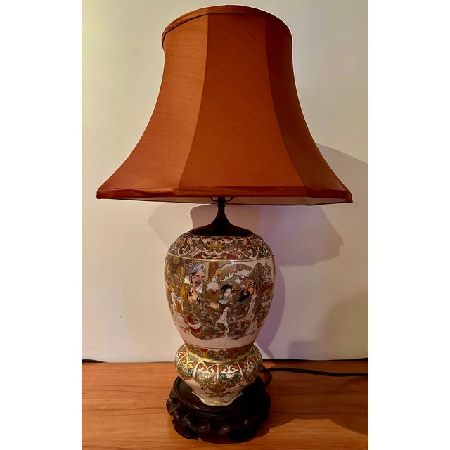 This late 19th century antique porcelain Chinese lamp showcasing the intricate craftsmanship and vibrant colors of the...