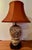 This late 19th century antique porcelain Chinese lamp showcasing the intricate craftsmanship and vibrant colors of the...