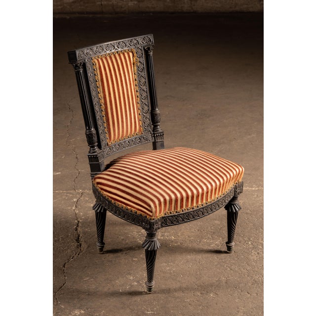 Late 19th-century Renaissance Revival side chair executed in ebonized hardwood with extensive foliate carving and...