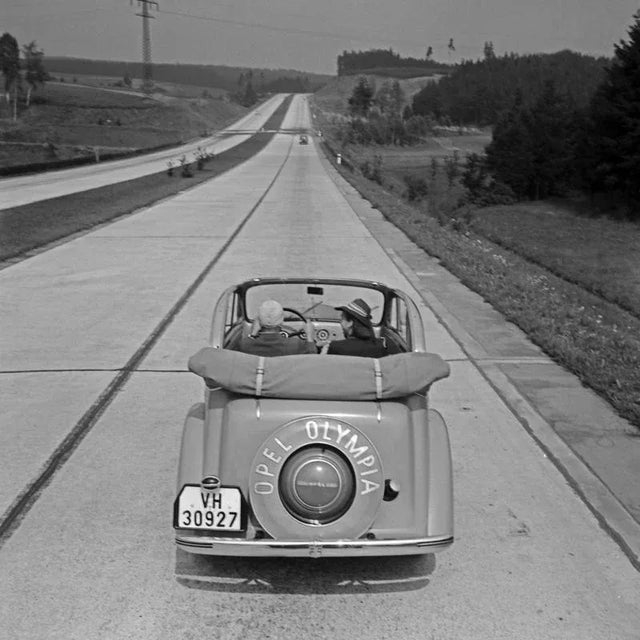 The photographer's note regarding this work is "Two women inside an Opel Olypmpia car while being on a trip through...