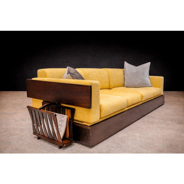 This Rosewood magazine rack by unknown designer, exemplifies the sculptural approach to utility characteristic of...