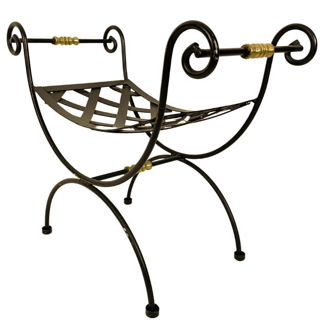 A 1940s blacksmith curule wrought iron bench in a neoclassical design with woven metal strapwork seat and scrolled arms...