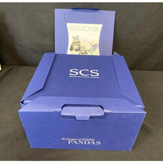 The product is a Swarovski figurine set featuring a Panda Bear mom and cub, from the Endangered Wildlife collection. This...