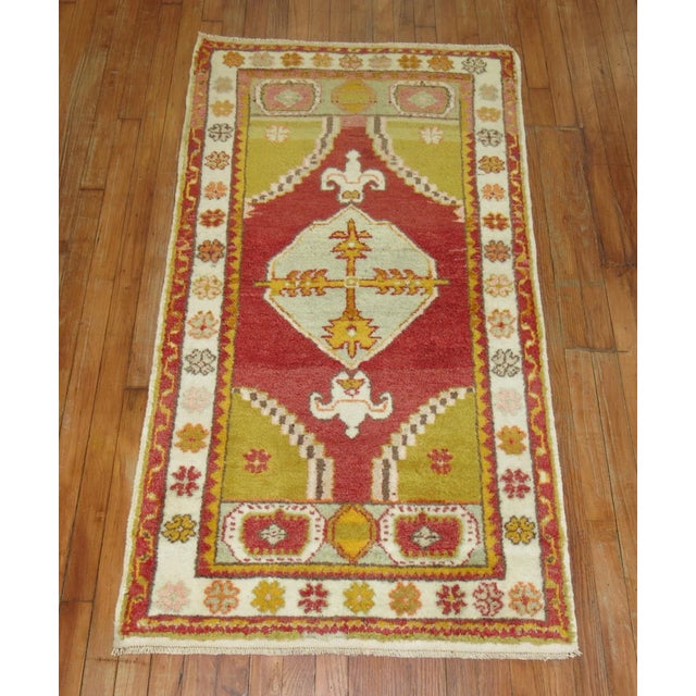 Mid 20th Century small throw size Turkish rug. This piece is a true antique, one-of-a-kind rug that has been...