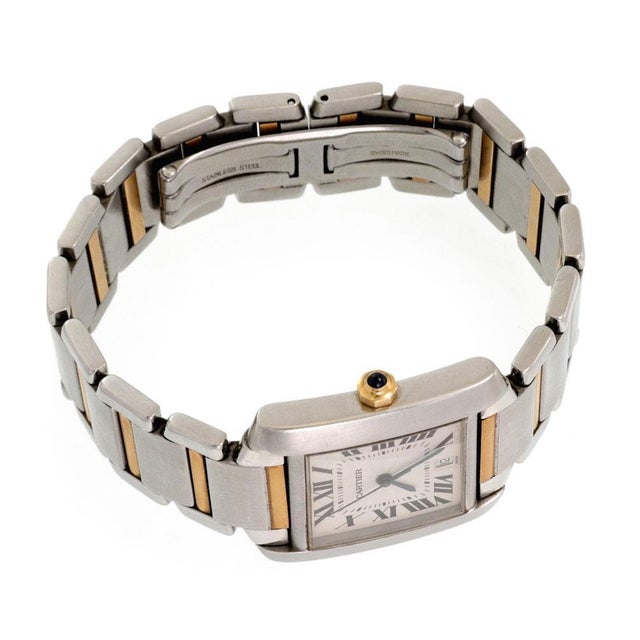 This bold authentic men's automatic wrist watch is by Cartier from the Tank Francaise Collection. Crafted from 18k yellow...