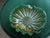 This hand blown image features a shell-like or ruffled design and incorporates a unique color palette such as green and...