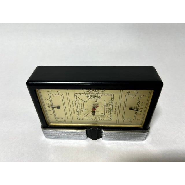 A classic 1940s Taylor Fairmont Junior Weather Station, featuring a thermometer, barometer, and hygrometer in an elegant...