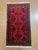 Hand-knotted Baluch rug, traditionally woven by tribal groups of eastern Iran and Afghanistan. Features a vivid red field...