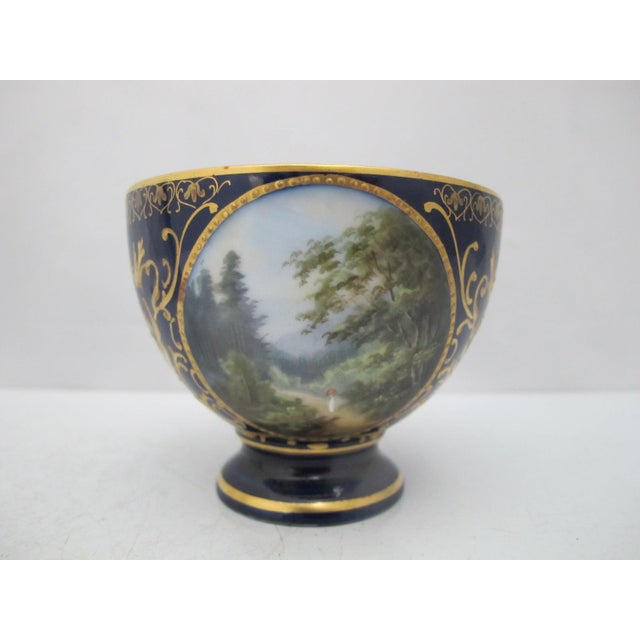 19th century, Karlsbad Hermann Voigt, Bohemia porcelain cup and saucer. Cobalt blue with ornate gilt accents and finely...