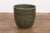 A Prem Collection large ceramic artisan hand crafted planter with green glaze, two toned textured finish, blotched accents...
