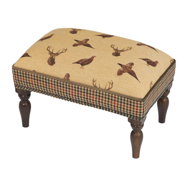 Meticulously handcrafted in the United Kingdom, this upholstered stool boasts classic studding and hand-polished solid...
