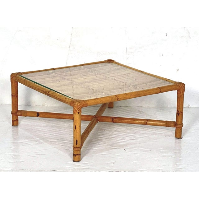 A fine Italian Mid-Century Modern bamboo and rattan low or coffee or cocktail table with removable glass top - featuring a...