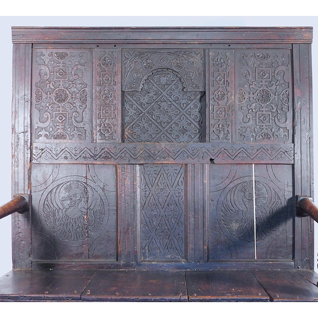 Jacobean Carved Oak Settle, English, c. 1680 This fine example of Jacobean period craftsmanship comes in the form of a...