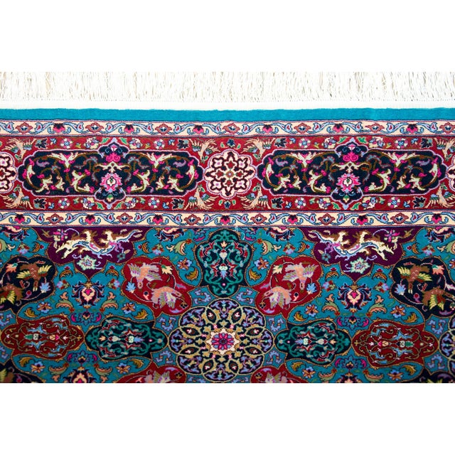 A late 20th century Persian Tabriz rug with the most wonderful mirrored stylized floral pattern woven in brilliant pinks,...